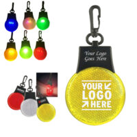 LED backpack safety light clipped to a bag with illuminated logo area in low-light conditions.