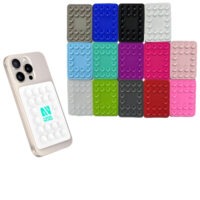 Silicone phone suction pad attached to the back of a smartphone in multiple color options.